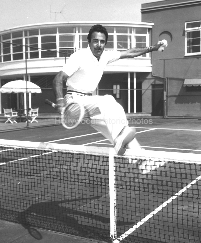 Beverly Hills Tennis Club 1954 340 Gilbert Roland jumping the net wm.jpg
